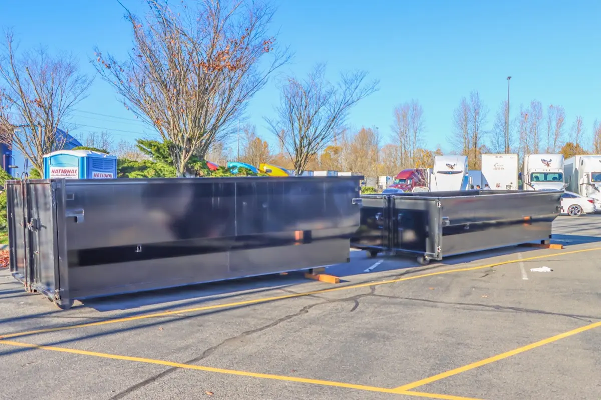 Professional dumpster rental service with roll-off container on residential driveway in Anthem